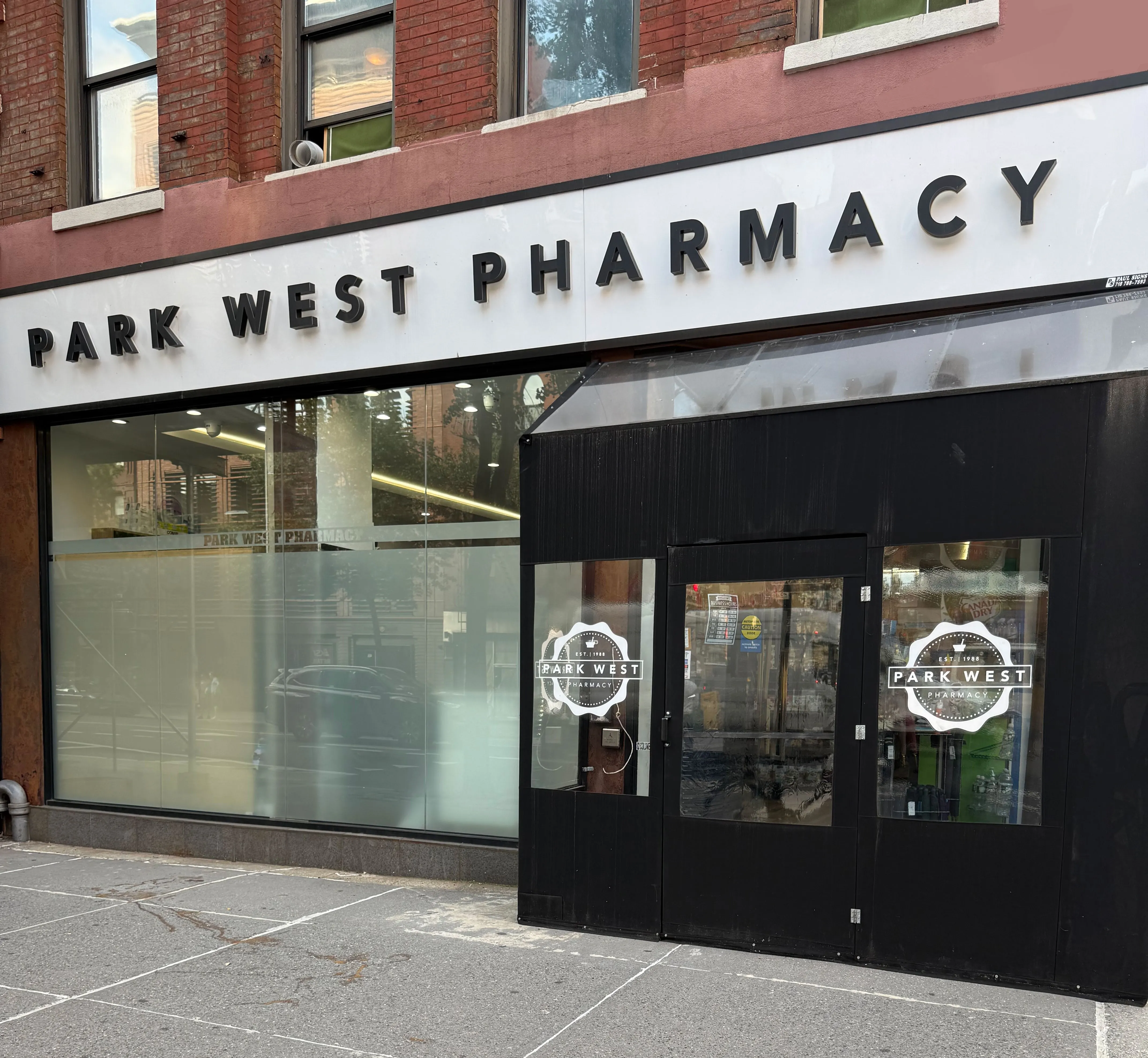 Pharmacist handing a prescription bag to a patient on the Upper West Side